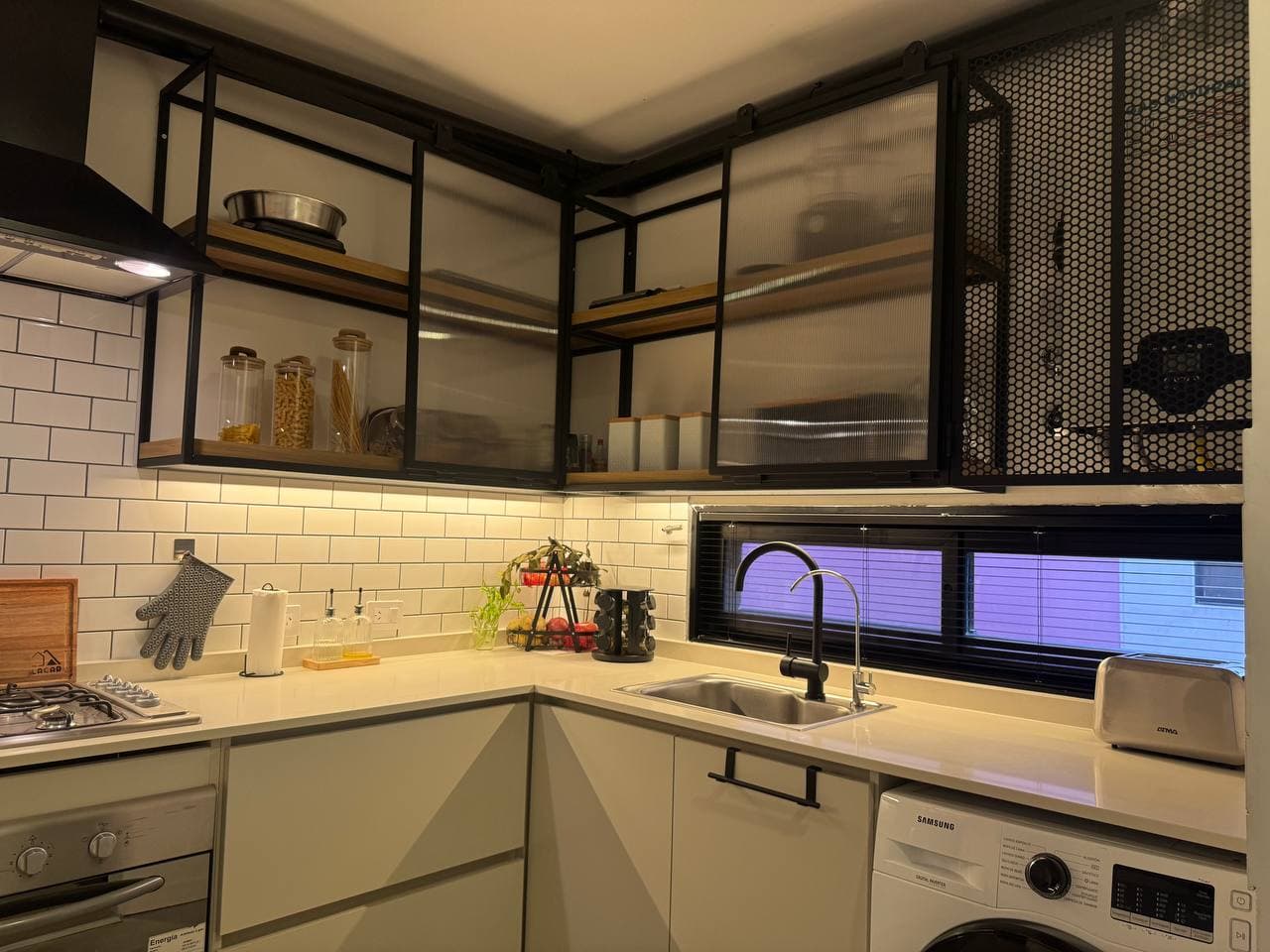 Cocina de estilo industrial con muebles de hierro y vidrio